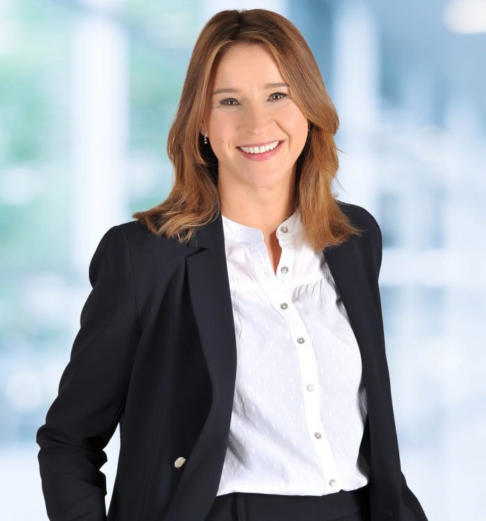 Blurred abstract background interior view looking out toward to empty office lobby and entrance doors and glass curtain wall with frame - blue white balance processing style